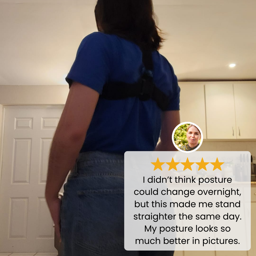 Posture corrector worn by a woman indoors shown from the back during a casual standing moment.