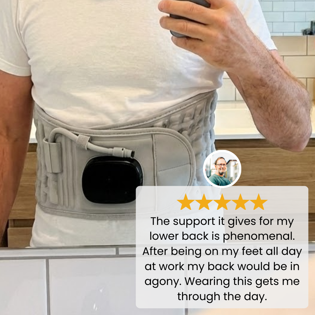 back massager worn around the waist by a man taking a mirror photo indoors