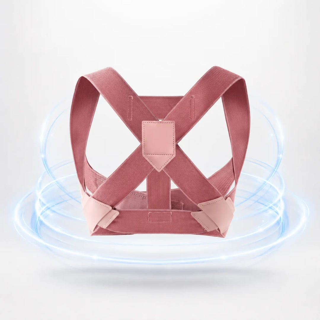 back brace for posture shown in pink with crossed elastic straps and a central back panel on a light background
