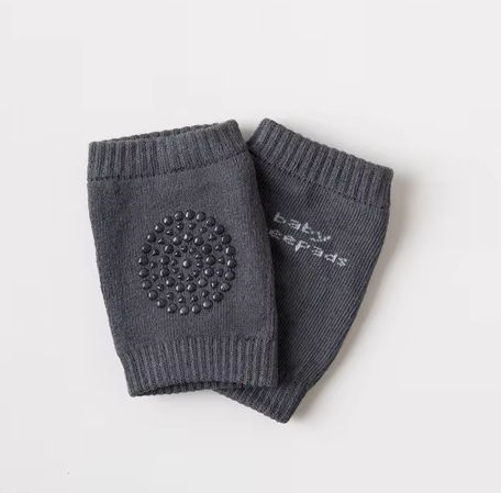 Kids knee sleeve shown alone as a gray pair with ribbed edges and a circular padded grip area visible.