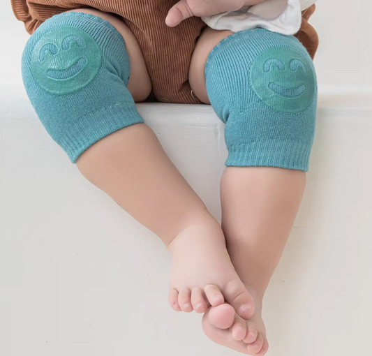 Kids knee sleeve worn on both knees of a baby sitting on a flat surface with padded knee areas visible.